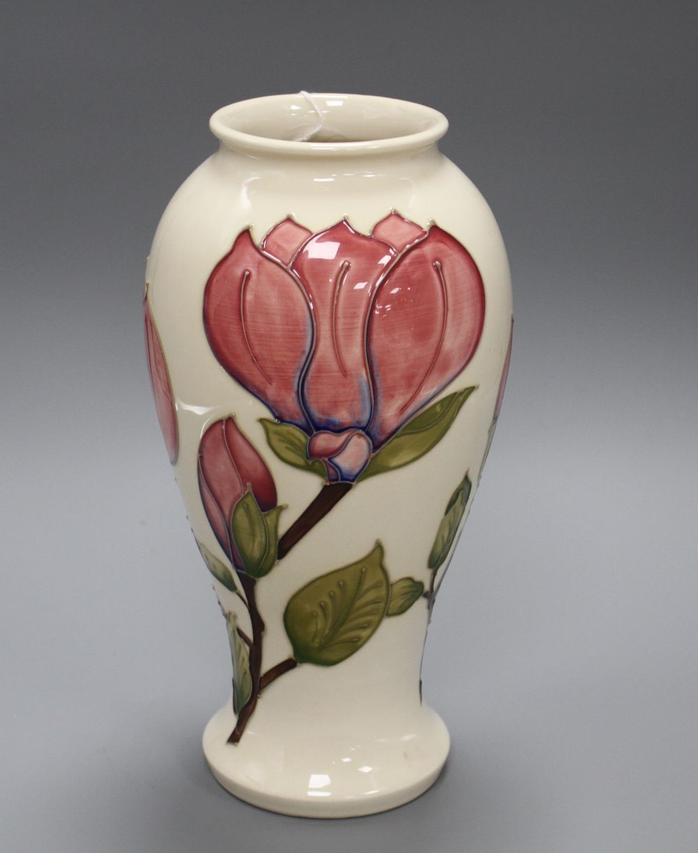 A Moorcroft magnolia pattern baluster vase, with pink flowers on a cream ground, height 31cm